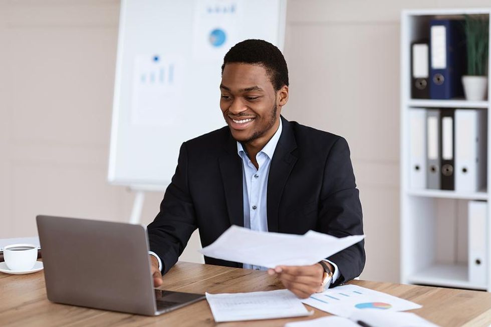 Young professional smiles while finding success on the job search,