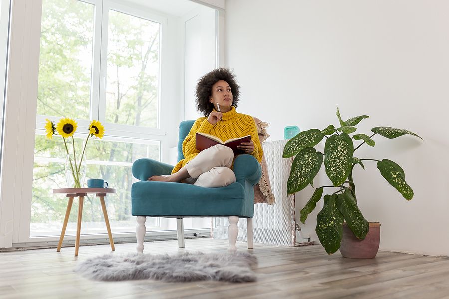 Young professional takes notes as she ponders her career goals
