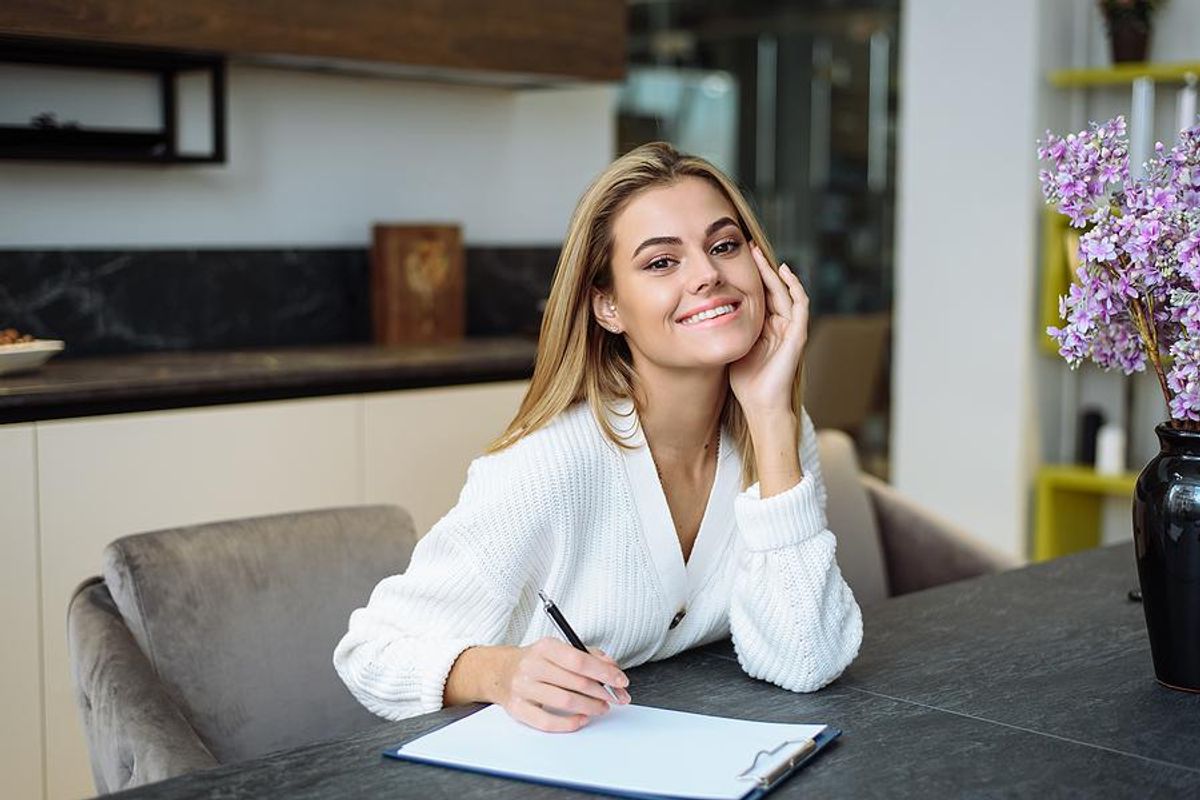 Young professional takes notes on her bucket list of companies that she wants to interview with