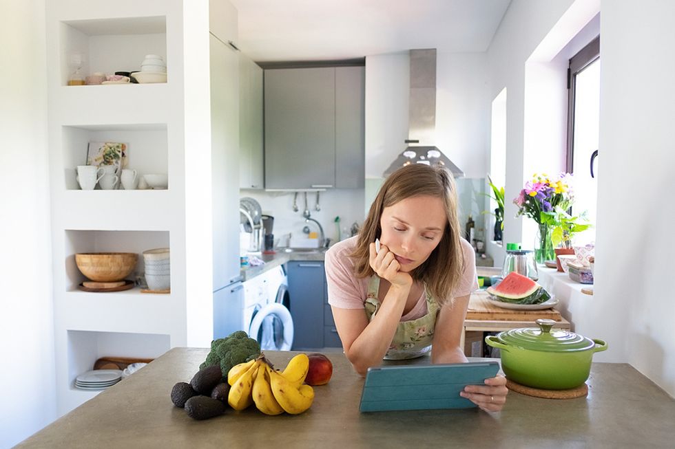 Young professional takes part in an online cooking class.