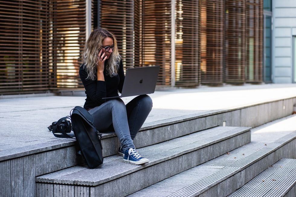 young professional updating her LinkedIn profile on her laptop