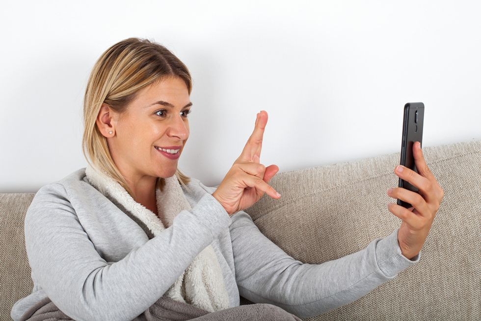 Young professional uses FaceTime to reconnect with a former colleague.