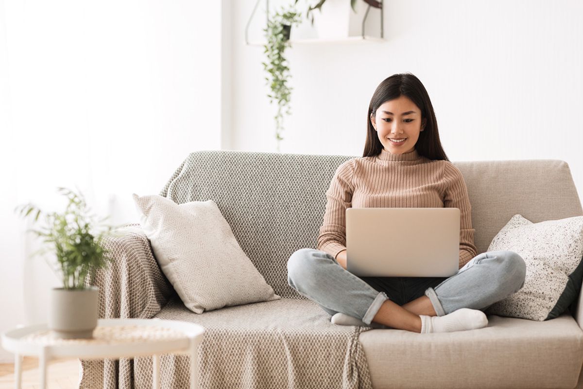 Young professional woman on laptop searches job postings online