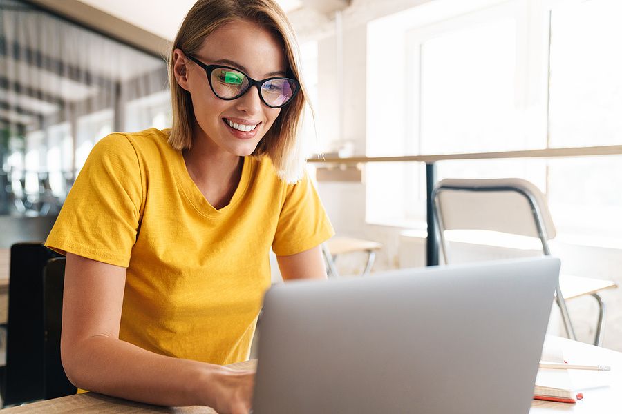 Young professional woman on laptop takes some spare time to work on her career plan
