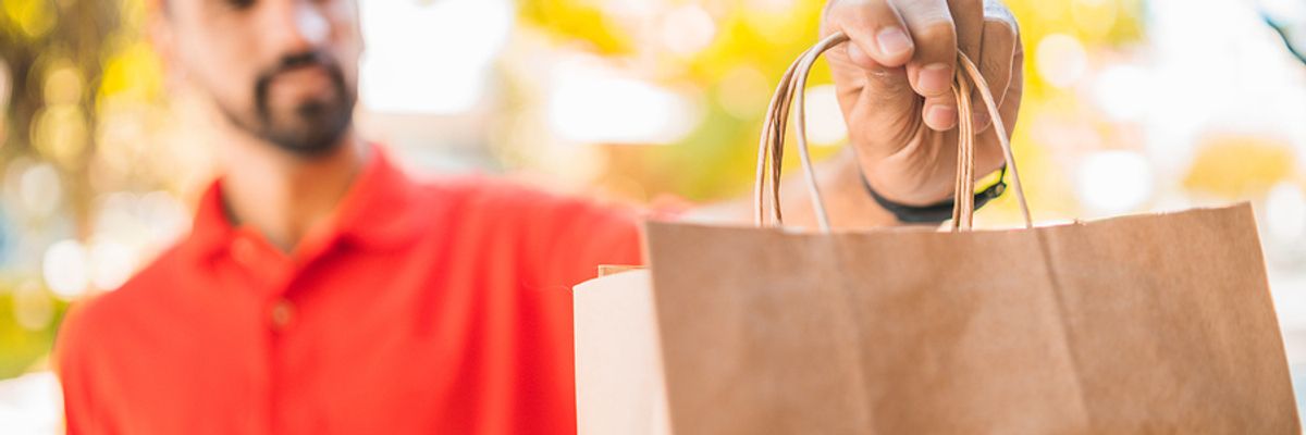 Young professional works a food delivery job.