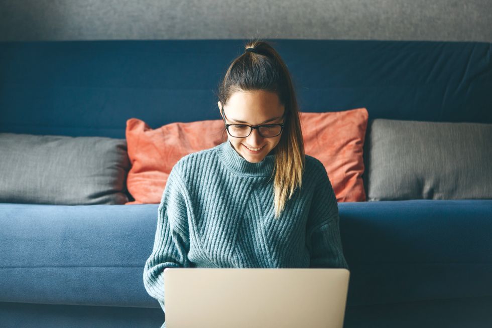 Young professional works on a freelance gig from home.