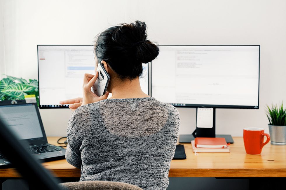 Young professional works on her job search from her own office.