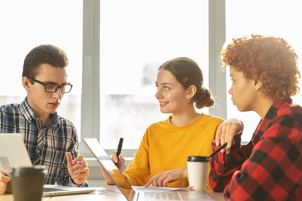 Young professionals talk during a work meeting