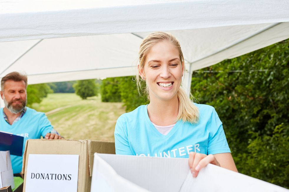 Young unemployed woman volunteering at a donation drive to fill time while she looks for a job