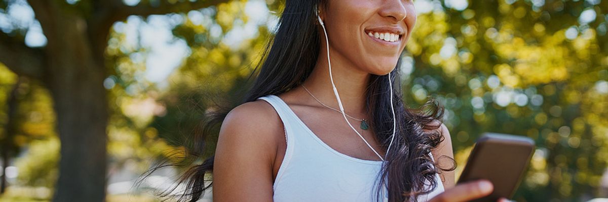 Young woman listens to podcast episodes while exercising