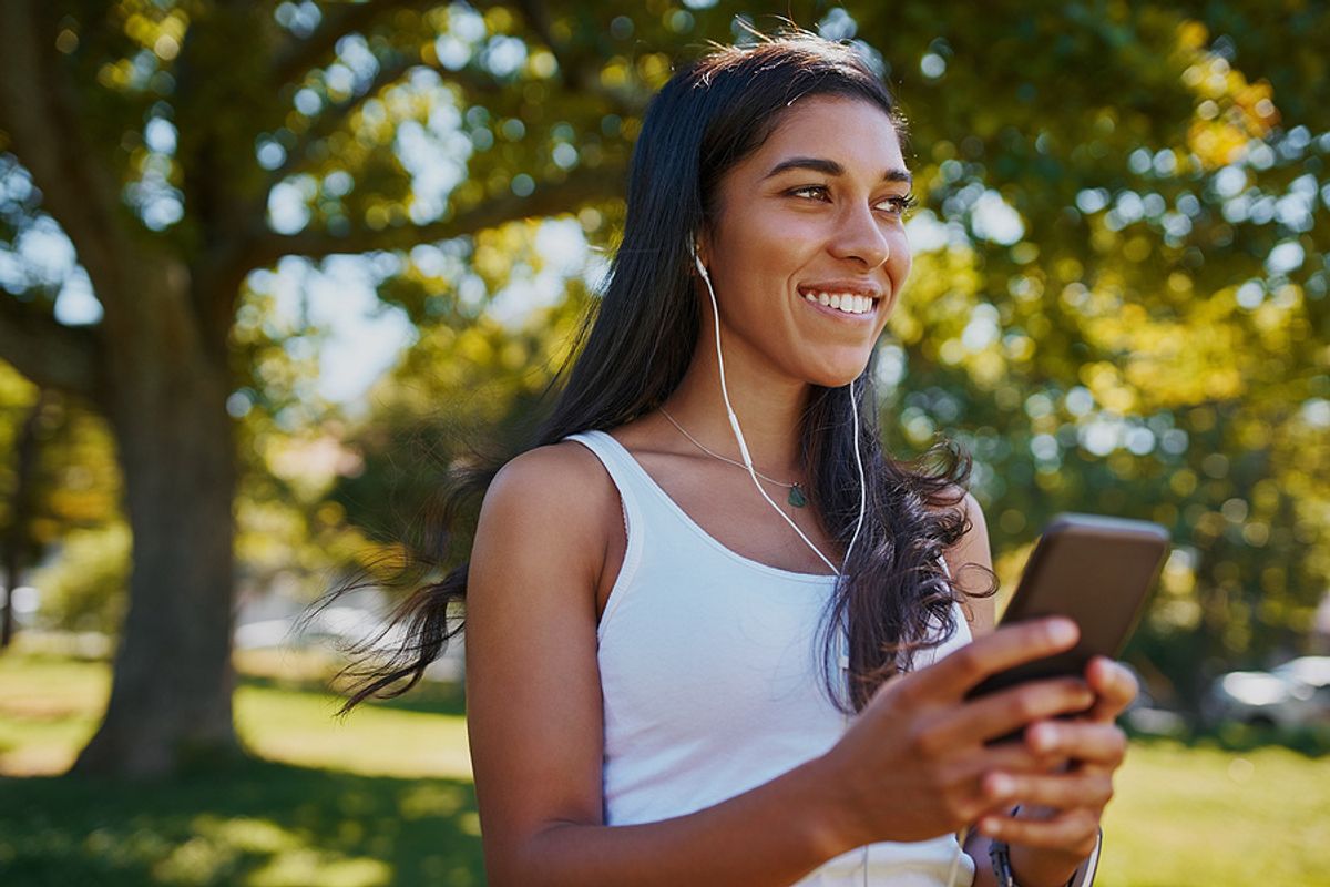 Young woman listens to podcast episodes while exercising