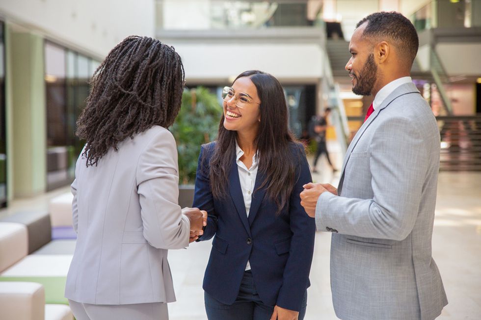 Young woman networks with colleagues at work