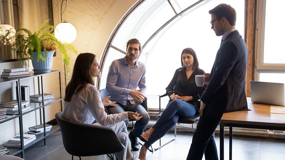 Young woman talks during a work meeting