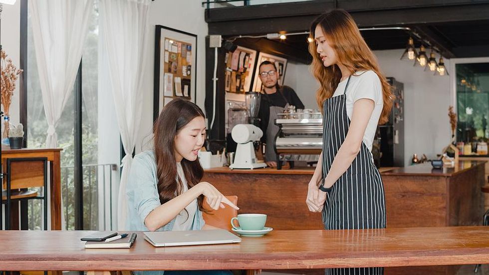 Young woman talks to an angry customer